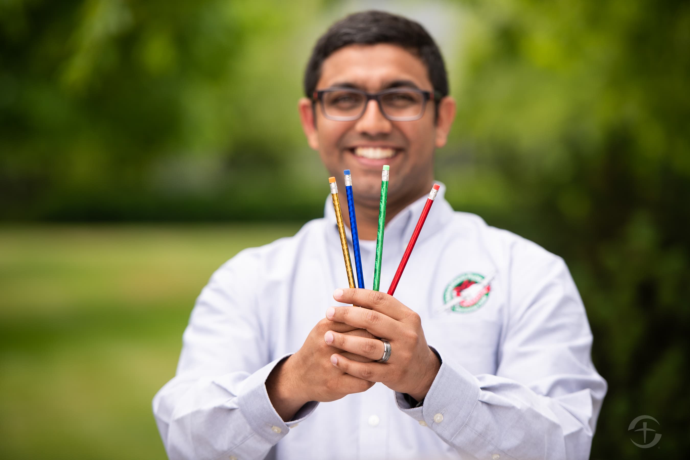 OCC spokesman Justin Thomas poses with 4 brand new pencils